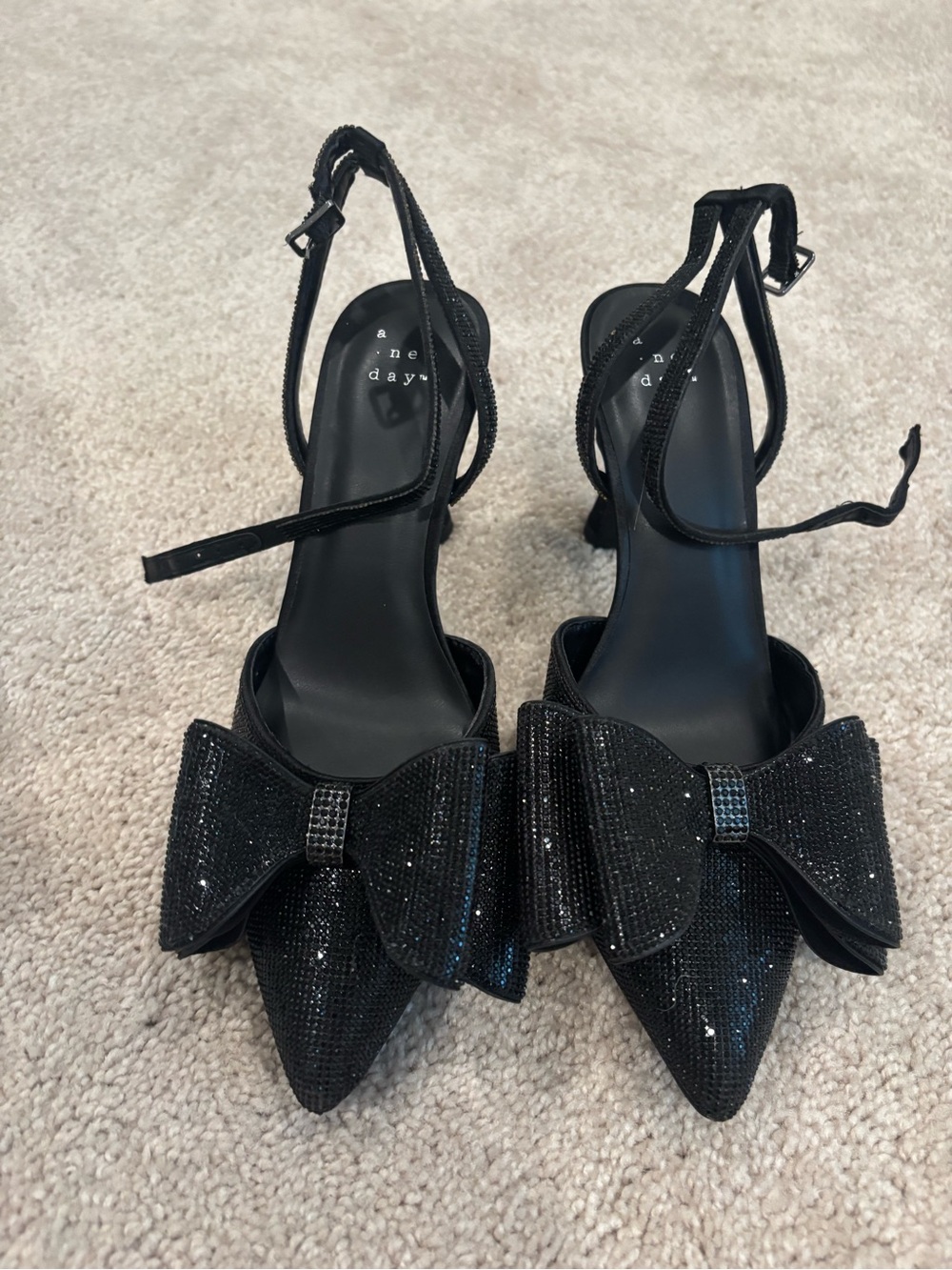 black bow-embellished slingback heels